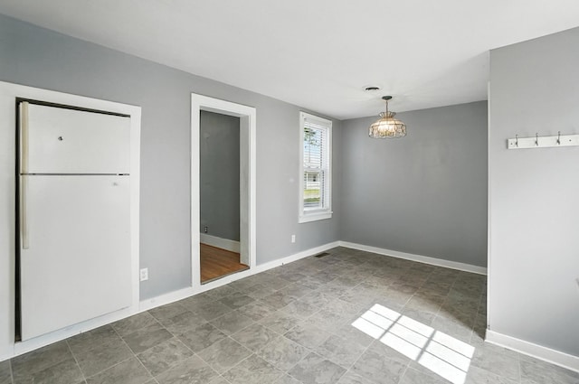224 Monroe St, Delphos, OH 45833 - unfurnished dining area with stone finish flooring and baseboards