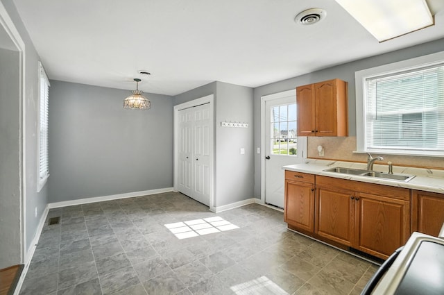 224 Monroe St, Delphos, OH 45833 - kitchen with light countertops, brown cabinets, and pendant lighting