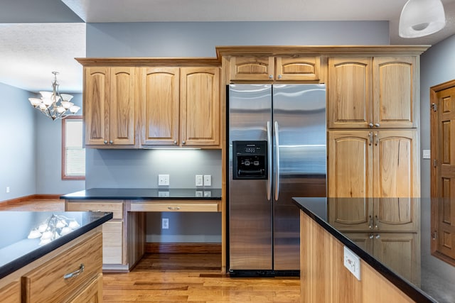 11370 Crottinger Rd, Plain City, OH 43064 - kitchen featuring stainless steel refrigerator with ice dispenser, dark countertops, light wood-style flooring, and baseboards