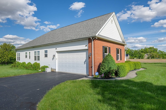 11370 Crottinger Rd, Plain City, OH 43064 - view of home's exterior featuring an attached garage, brick siding, a lawn, and driveway