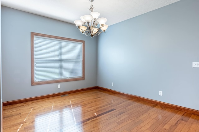 11370 Crottinger Rd, Plain City, OH 43064 - empty room featuring a chandelier, plenty of natural light, and baseboards