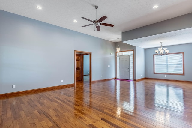 11370 Crottinger Rd, Plain City, OH 43064 - unfurnished room with light wood-type flooring, ceiling fan, a chandelier, baseboards, and a textured ceiling