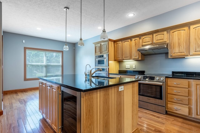 11370 Crottinger Rd, Plain City, OH 43064 - kitchen with wine cooler, appliances with stainless steel finishes, under cabinet range hood, a sink, and dark countertops