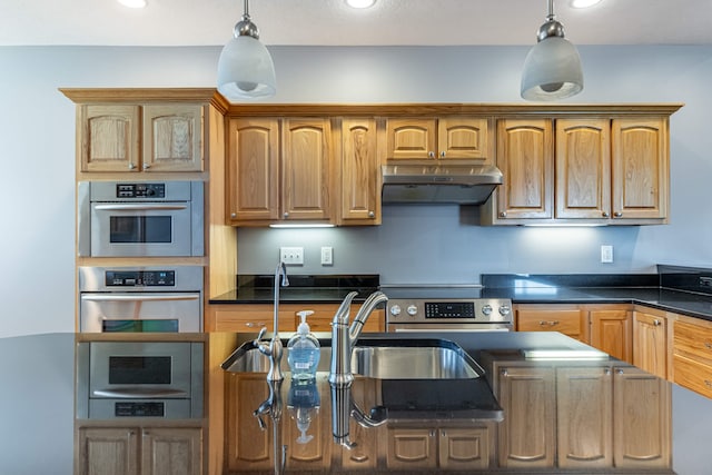 11370 Crottinger Rd, Plain City, OH 43064 - kitchen featuring under cabinet range hood, dark countertops, appliances with stainless steel finishes, hanging light fixtures, and a sink
