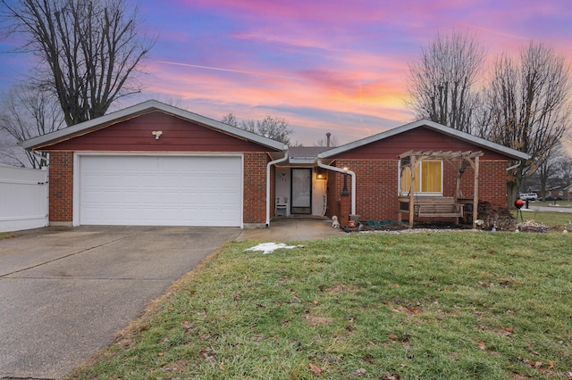 single story home with a garage and a lawn