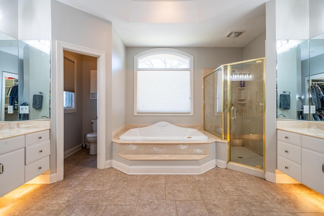 full bath with a garden tub, toilet, a shower stall, baseboards, and vanity