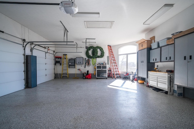 garage with electric panel and a garage door opener