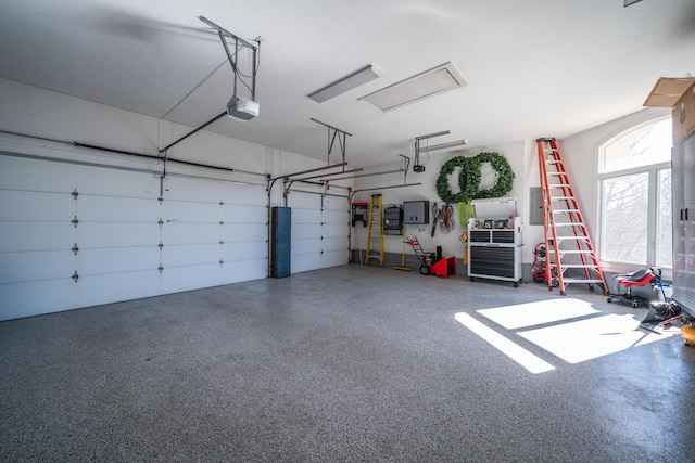 garage featuring electric panel and a garage door opener