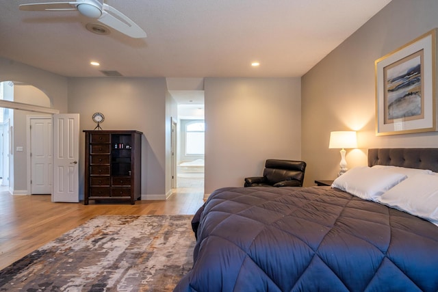 bedroom with recessed lighting, visible vents, baseboards, and wood finished floors