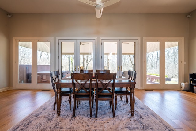 dining area featuring visible vents, french doors, ceiling fan, and wood finished floors