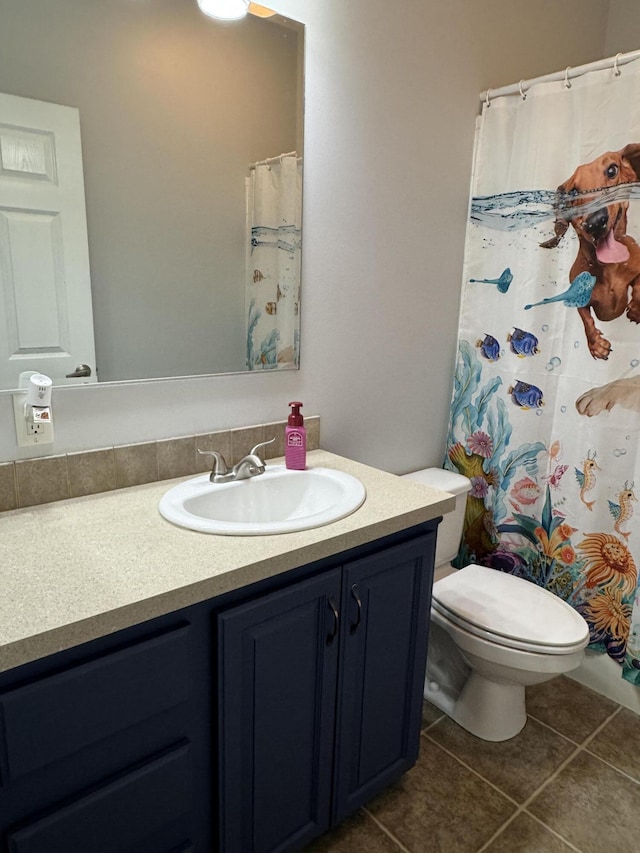 bathroom with vanity, tile patterned floors, and toilet