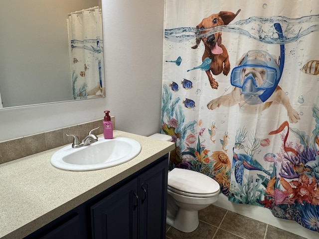 bathroom with vanity, toilet, and tile patterned flooring