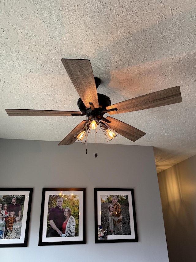 room details featuring ceiling fan and a textured ceiling