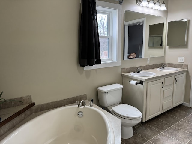 bathroom featuring vanity, tile patterned floors, a tub, and toilet