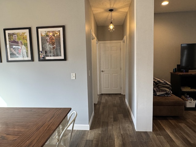 corridor featuring dark hardwood / wood-style floors