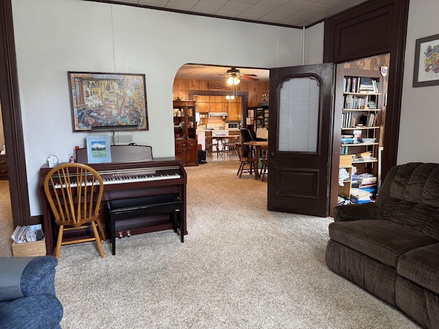 210 E Second St, Rockford, OH 45882 - living area featuring light colored carpet, arched walkways, and ceiling fan