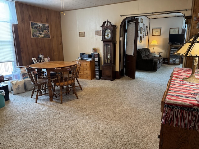 210 E Second St, Rockford, OH 45882 - dining room featuring carpet flooring, wooden walls, and arched walkways