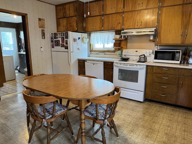 210 E Second St, Rockford, OH 45882 - kitchen featuring white appliances, under cabinet range hood, light floors, washer / dryer, and light countertops