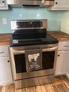 4173 Navajo Trl, Jamestown, OH 45335 - kitchen featuring electric stove, white cabinets, and light wood-style floors