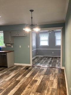 4173 Navajo Trl, Jamestown, OH 45335 - unfurnished dining area with dark wood-style flooring, plenty of natural light, and a chandelier