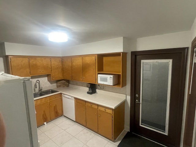 2412 W Spring St, Lima, OH 45805 - kitchen with white appliances, a sink, open shelves, light countertops, and light tile patterned flooring