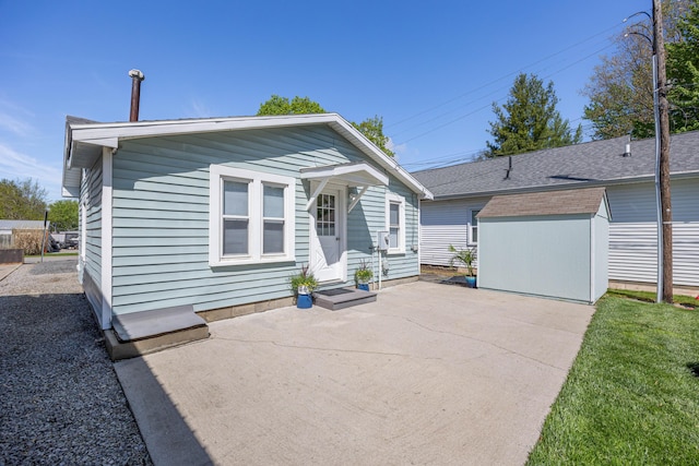11068 Big Bear Path, Lakeview, OH 43331 - rear view of house with a storage unit, a patio, and an outdoor structure