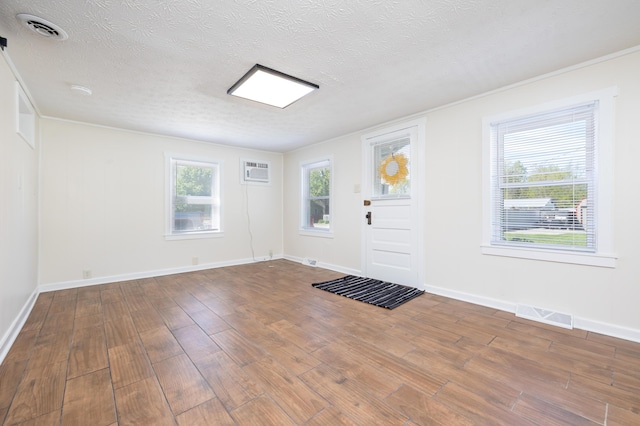 11068 Big Bear Path, Lakeview, OH 43331 - entryway with wood finished floors, a textured ceiling, a wall mounted air conditioner, and baseboards