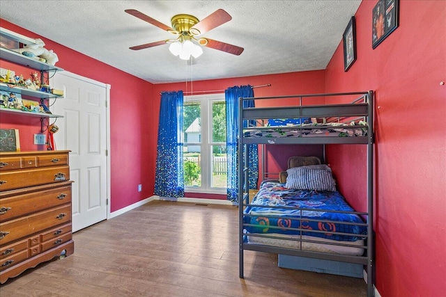 10474 Columbus St, East Liberty, OH 43319 - bedroom with a textured ceiling, wood finished floors, and a ceiling fan
