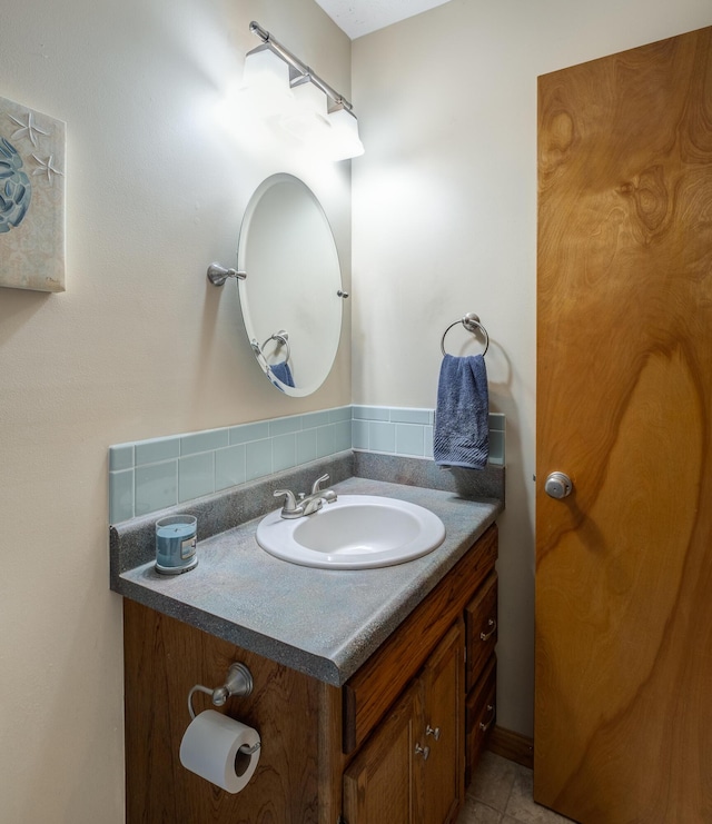 bathroom featuring vanity, backsplash, and tile patterned flooring