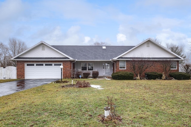 ranch-style house featuring a garage and a front yard