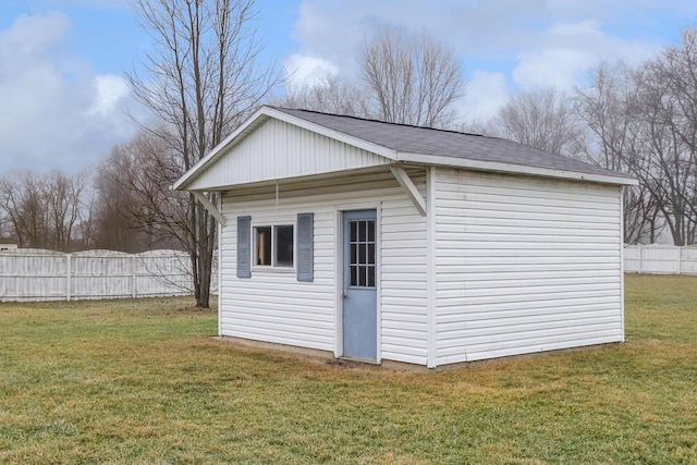 view of home's exterior with an outdoor structure and a lawn