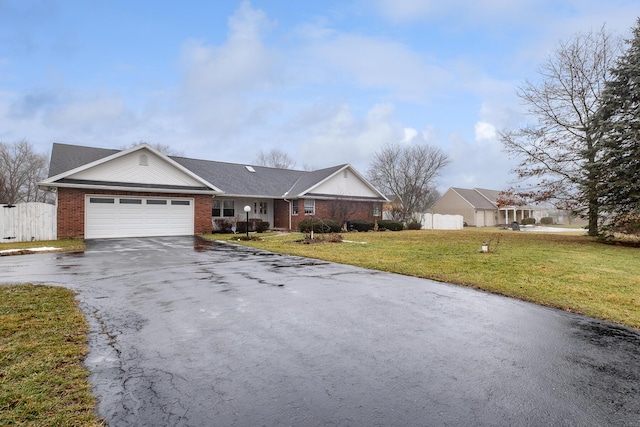 ranch-style house featuring a garage and a front lawn