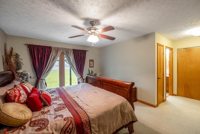 carpeted bedroom with a textured ceiling, access to outside, and ceiling fan