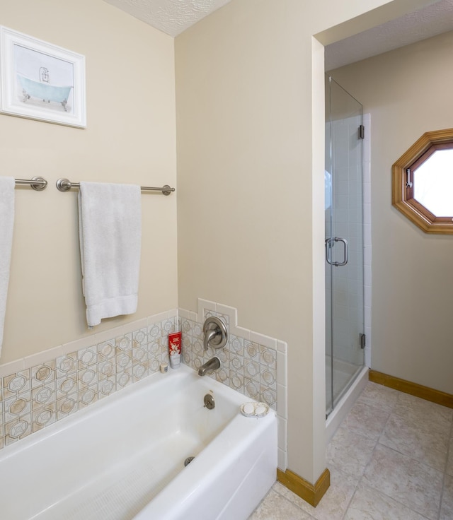 bathroom with plus walk in shower, tile patterned flooring, and a textured ceiling