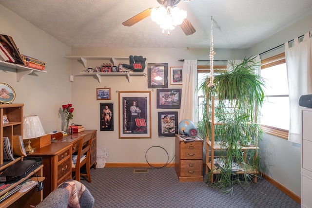 carpeted office space featuring ceiling fan and a textured ceiling