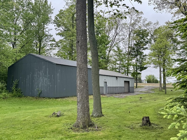 18866 Weimert School Rd, Wapakoneta, OH 45895 - view of green lawn with a pole building, a detached garage, an outbuilding, and driveway