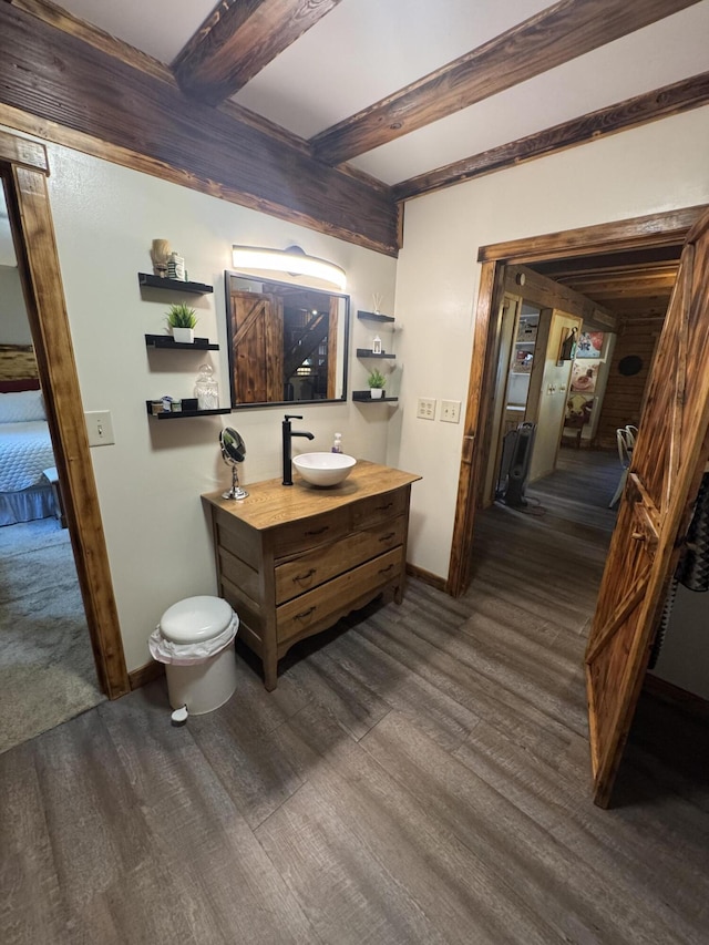 18866 Weimert School Rd, Wapakoneta, OH 45895 - bathroom featuring wood finished floors, beam ceiling, baseboards, vanity, and ensuite bath