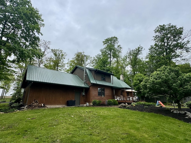 18866 Weimert School Rd, Wapakoneta, OH 45895 - back of house featuring a lawn, metal roof, and a chimney