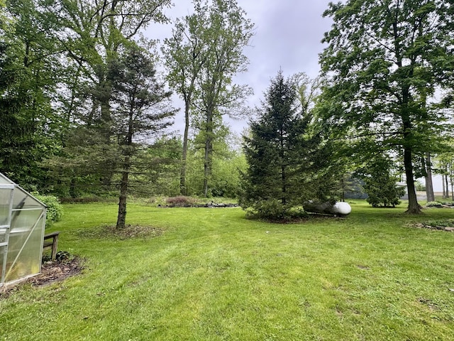18866 Weimert School Rd, Wapakoneta, OH 45895 - view of green lawn with an exterior structure and an outbuilding