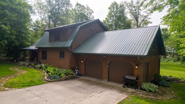18866 Weimert School Rd, Wapakoneta, OH 45895 - view of side of home with a chimney, metal roof, a yard, and concrete driveway