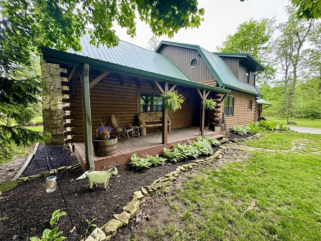 18866 Weimert School Rd, Wapakoneta, OH 45895 - back of house featuring log exterior, metal roof, a lawn, and a wooden deck