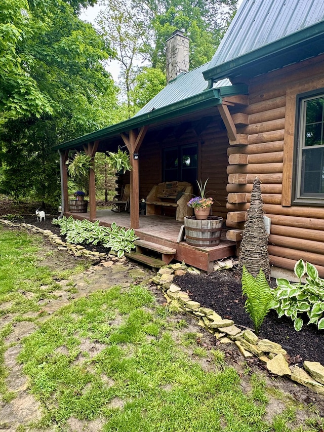 18866 Weimert School Rd, Wapakoneta, OH 45895 - view of side of home with a chimney, a wooden deck, log exterior, and metal roof