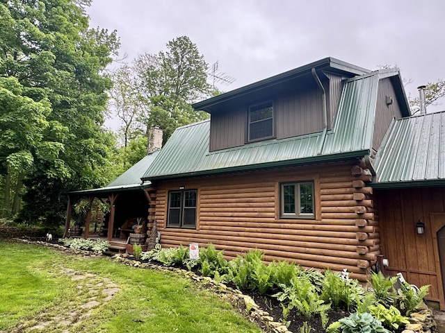 18866 Weimert School Rd, Wapakoneta, OH 45895 - view of side of home with metal roof, a chimney, log siding, and a lawn