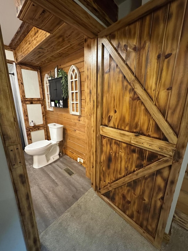 18866 Weimert School Rd, Wapakoneta, OH 45895 - bathroom with wood walls, toilet, and wood finished floors