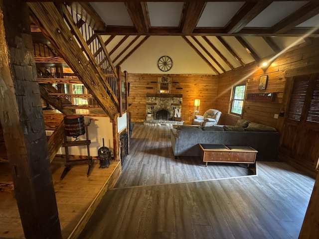 18866 Weimert School Rd, Wapakoneta, OH 45895 - living area with wood-type flooring, wood walls, beamed ceiling, high vaulted ceiling, and stairs
