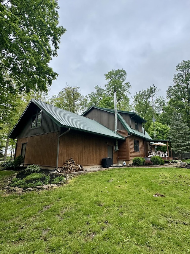 18866 Weimert School Rd, Wapakoneta, OH 45895 - view of home's exterior featuring a yard, metal roof, and central AC