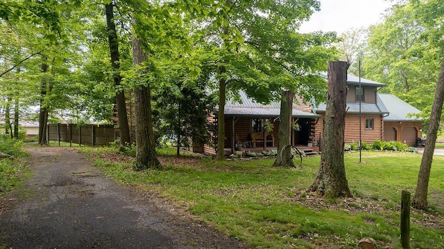 18866 Weimert School Rd, Wapakoneta, OH 45895 - view of front of home with metal roof, a chimney, a porch, and log exterior