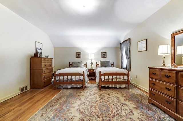407 N Broadmoor Blvd, Springfield, OH 45504 - bedroom with vaulted ceiling, light wood finished floors, and baseboards