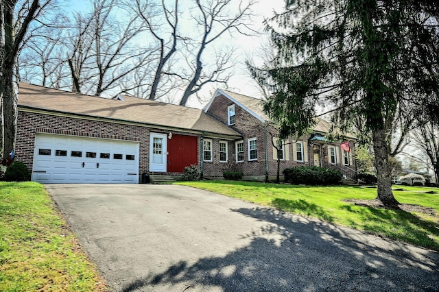 407 N Broadmoor Blvd, Springfield, OH 45504 - traditional-style house with driveway, brick siding, a garage, a front lawn, and entry steps