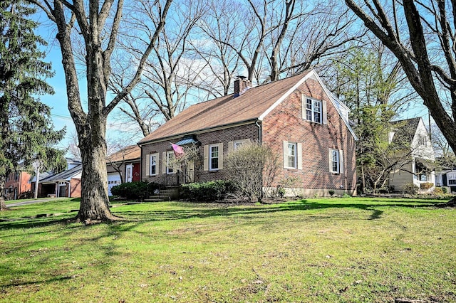 407 N Broadmoor Blvd, Springfield, OH 45504 - view of front of property with a chimney, brick siding, and a front lawn